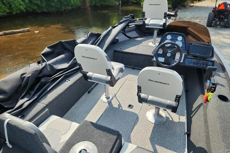Slide: The Image of 2024 Polar Kraft Frontier 165 SCJ boat interior with seating and steering console. - 32