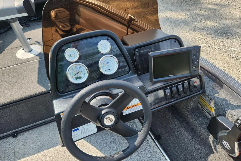 Slide: The Image of 2024 Polar Kraft Frontier 165 SCJ boat dashboard with steering wheel and gauges. - 33