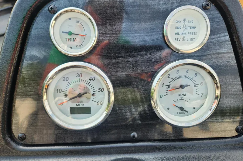 Slide: The Image of Dashboard gauges of 2024 Polar Kraft Frontier 165 SCJ boat, showing trim, speed, RPM, and fuel levels. - 34