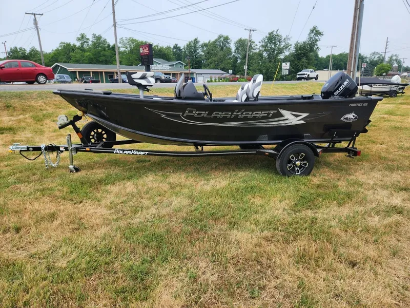 Slide: The Image of 2024 Polar Kraft Frontier 165 SCJ boat on trailer, parked on grass. - 4