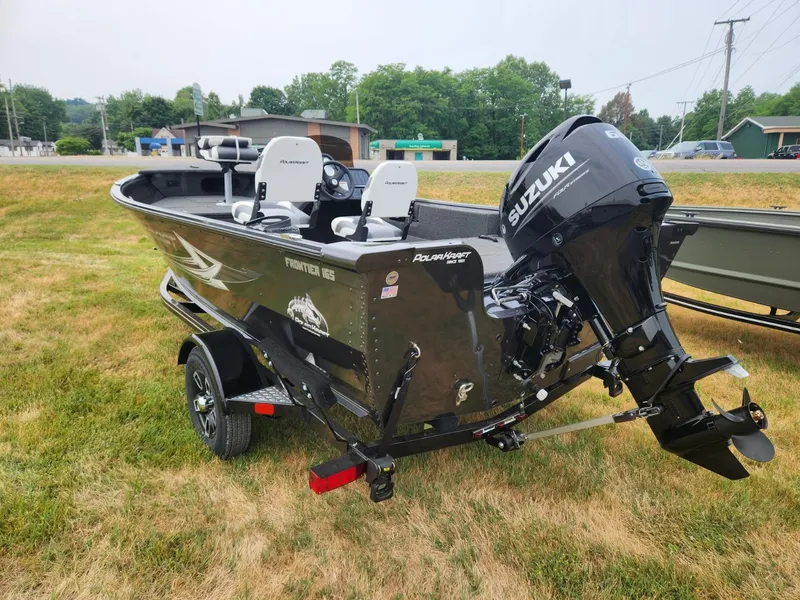 Slide: The Image of 2024 Polar Kraft Frontier 165 SCJ boat with Suzuki motor on grassy area. - 5