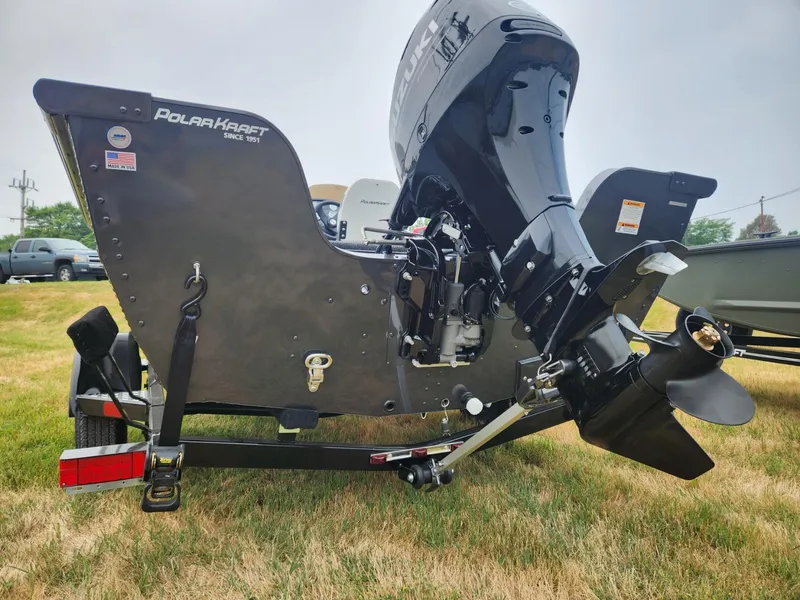 Slide: The Image of 2024 Polar Kraft Frontier 165 SCJ boat with outboard motor on grass. - 6