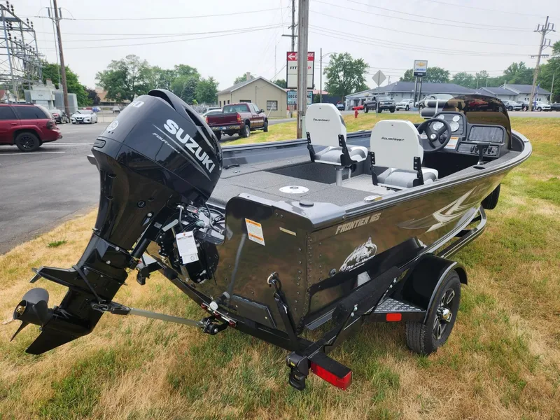 Slide: The Image of 2024 Polar Kraft Frontier 165 SCJ boat with Suzuki engine, parked on grass. - 7