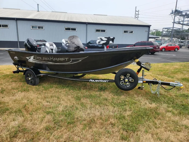 Slide: The Image of 2024 Polar Kraft Frontier 165 SCJ boat on trailer, parked on grass. - 8