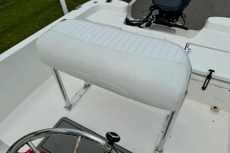 Slide: The Image of 2013 NauticStar 1910 NauticBay boat seat and steering wheel, white upholstery. - 10