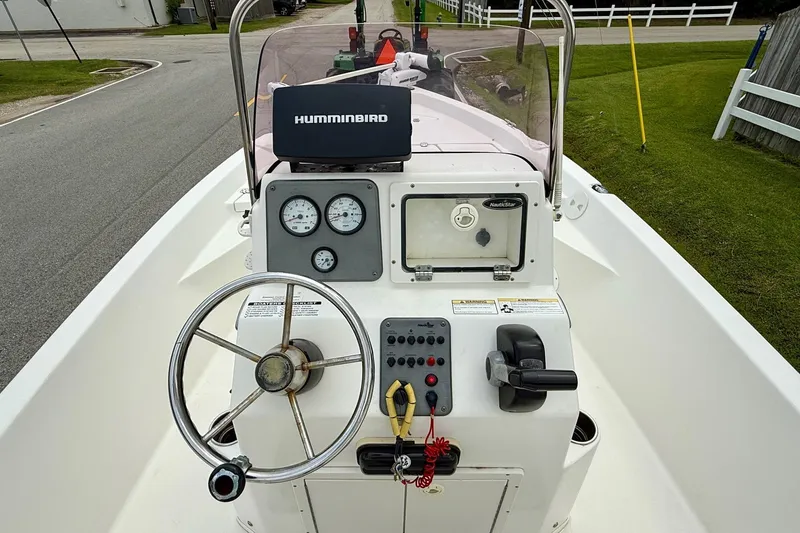 Slide: The Image of 2013 NauticStar 1910 NauticBay boat console with steering wheel and navigation equipment. - 11