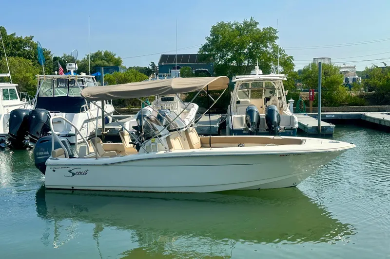 Slide: The Image of 2023 Scout 195 Sport Dorado boat docked in a marina, featuring a Yamaha outboard motor. - 10