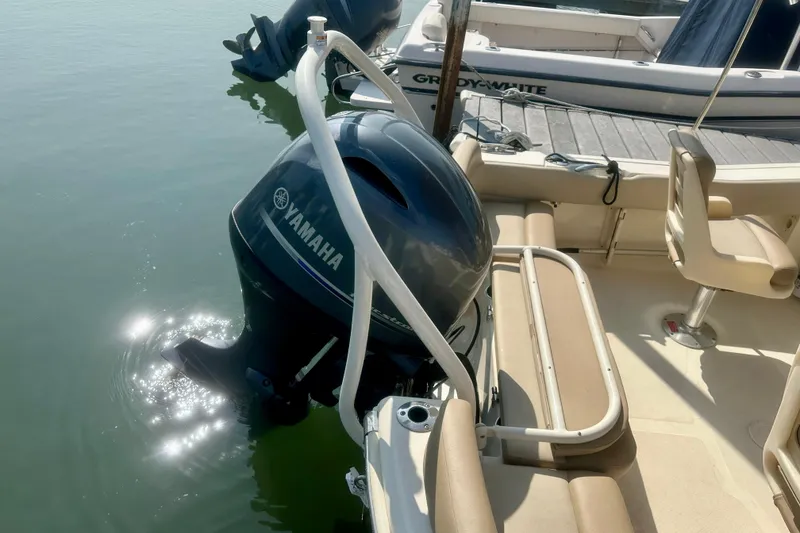 Slide: The Image of 2023 Scout 195 Sport Dorado with Yamaha outboard engine, docked beside another boat. - 4