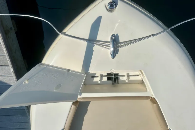 Slide: The Image of 2023 Scout 195 Sport Dorado boat bow with open hatch and rope cleat. - 5