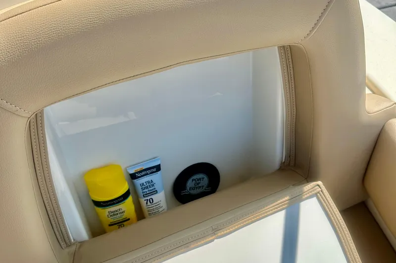 Slide: The Image of 2023 Scout 195 Sport Dorado storage compartment with sunscreen and accessories. - 6