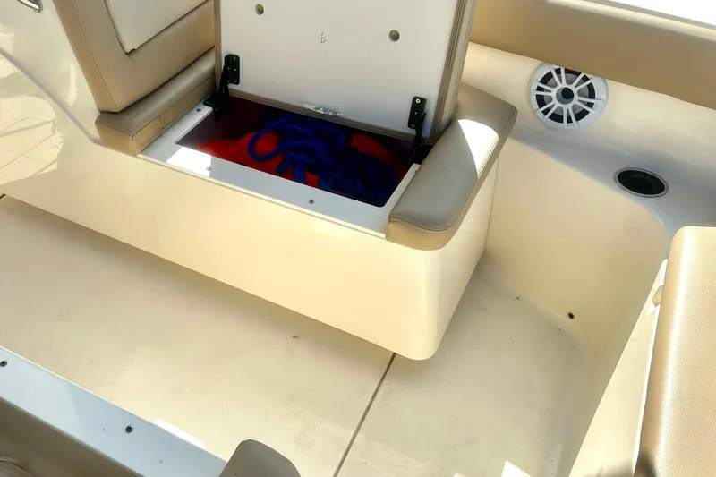 Slide: The Image of 2023 Scout 195 Sport Dorado boat interior with open storage compartment. - 8