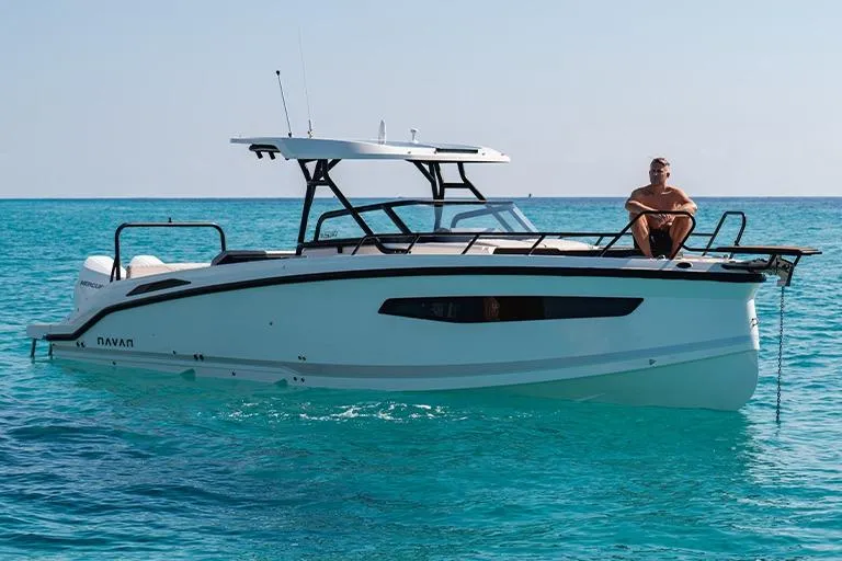 The Image of 2026 Navan S30 boat on clear blue water with person sitting on deck. - 1