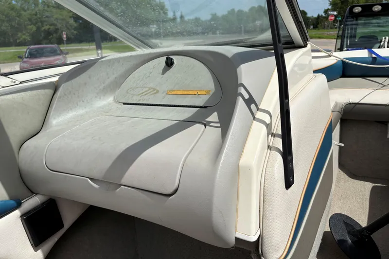Slide: The Image of 1995 Bayliner Maxum boat interior with white upholstery and dashboard details. - 17