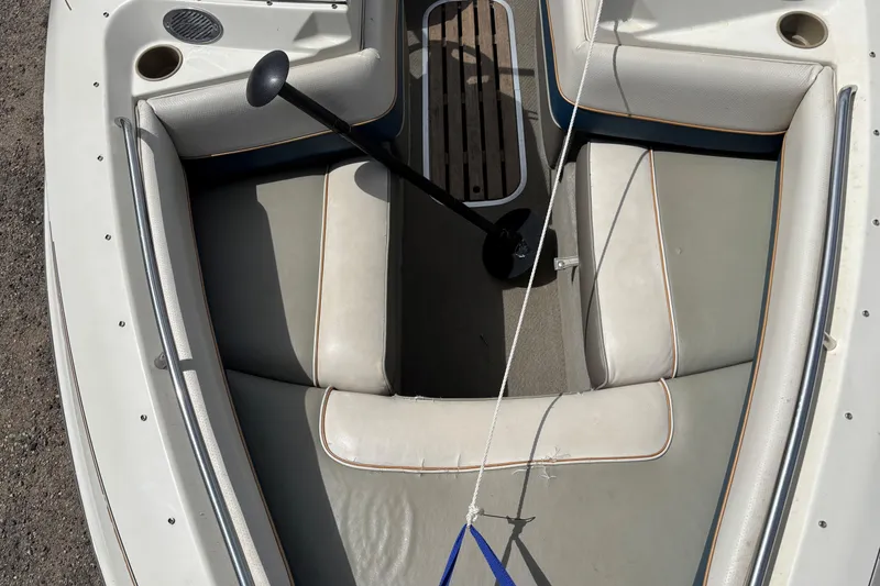 Slide: The Image of 1995 Bayliner Maxum boat interior with beige seating and a black anchor. - 18