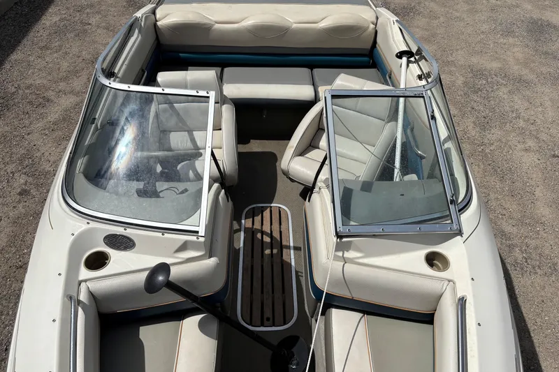 Slide: The Image of 1995 Bayliner Maxum boat interior with beige seating and open windshield. - 19