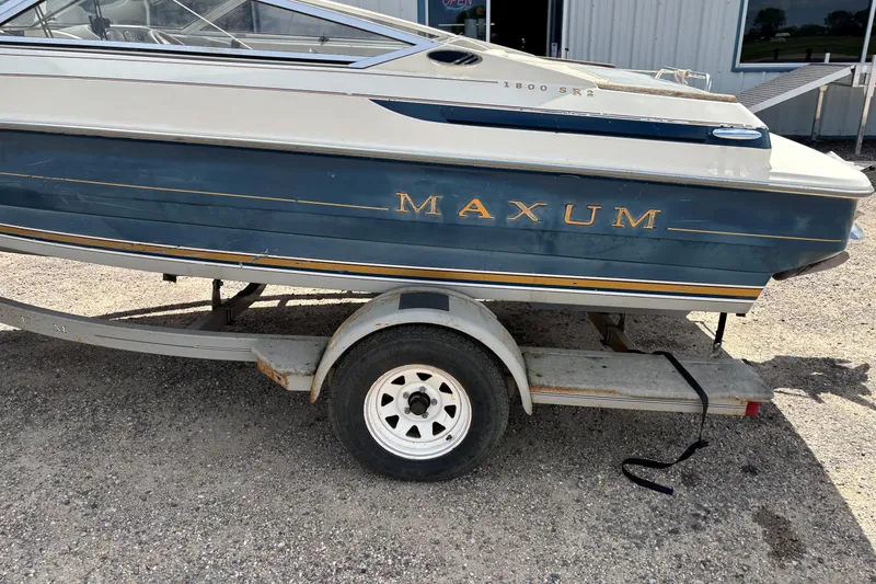 Slide: The Image of 1995 Bayliner Maxum boat on trailer, side view, blue and white exterior. - 3