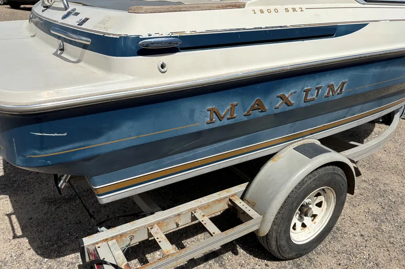 Slide: The Image of 1995 Bayliner Maxum 1800 SR2 boat on trailer, blue and white exterior. - 6