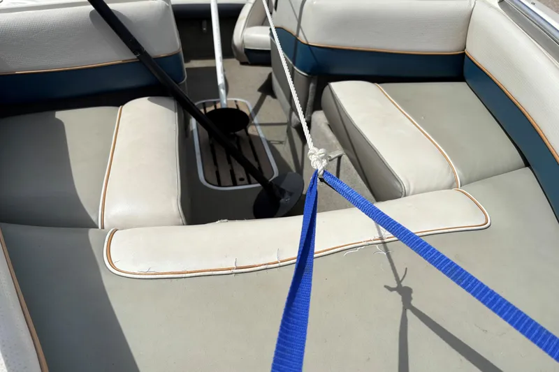 Slide: The Image of Interior of a 1995 Bayliner Maxum boat with seating and ropes. - 9