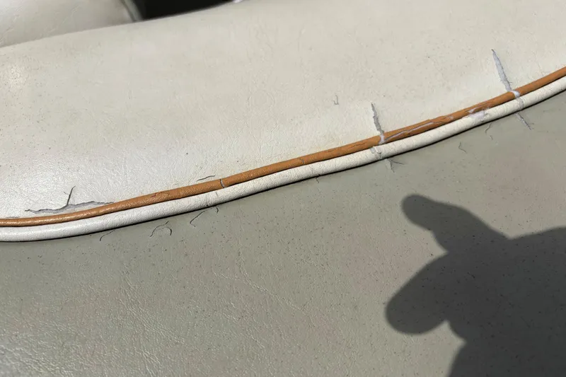 Slide: The Image of Cracked upholstery on 1995 Bayliner Maxum boat seat, showing wear and tear. - 10
