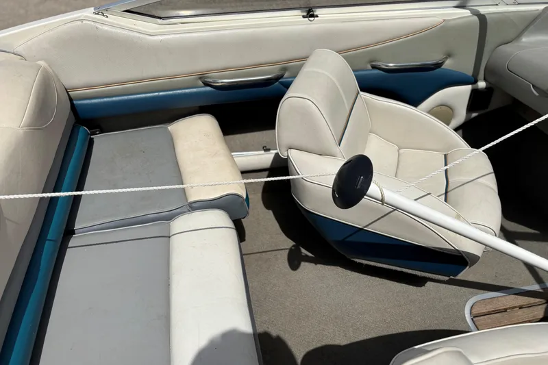 Slide: The Image of Interior of a 1995 Bayliner Maxum boat with white and blue seating. - 11
