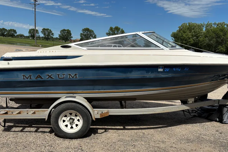 Slide: The Image of 1995 Bayliner Maxum boat on trailer, parked outdoors under a clear sky. - 5