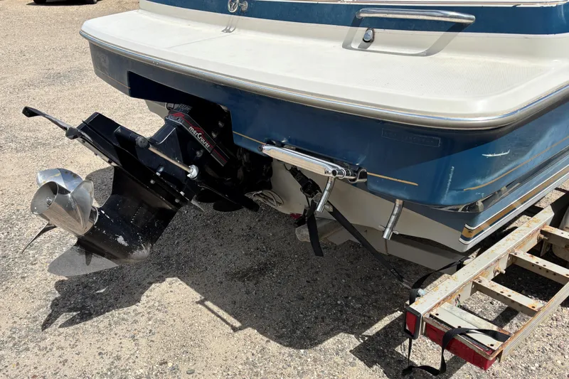 Slide: The Image of 1995 Bayliner Maxum boat stern with outboard motor on a trailer. - 7