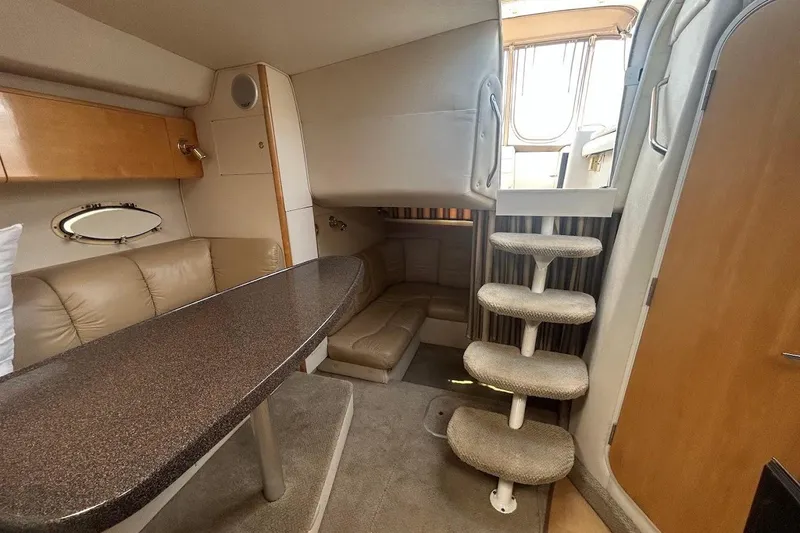 Slide: The Image of Interior of 2001 Larson Cabrio 330 boat with seating, table, and stairs. - 15