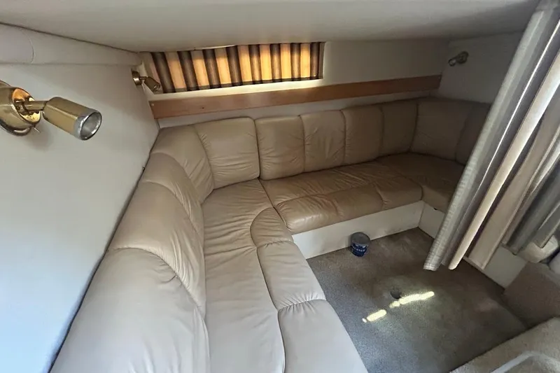 Slide: The Image of 2001 Larson Cabrio 330 interior with beige leather seating and cozy lighting. - 18