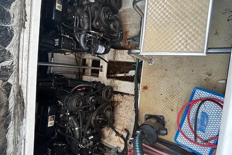 Slide: The Image of Engine compartment of a 2001 Larson Cabrio 330 boat, showing dual engines and equipment. - 19