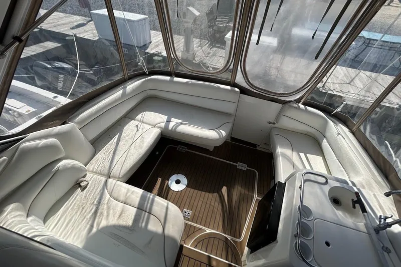 Slide: The Image of 2001 Larson Cabrio 330 boat interior with white seating and wooden flooring. - 3