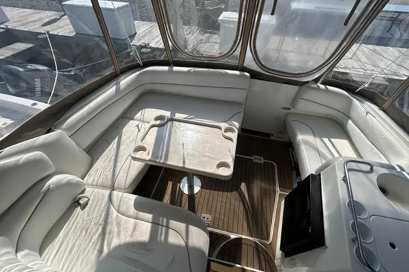 Slide: The Image of 2001 Larson Cabrio 330 boat interior with white seating and table. - 5