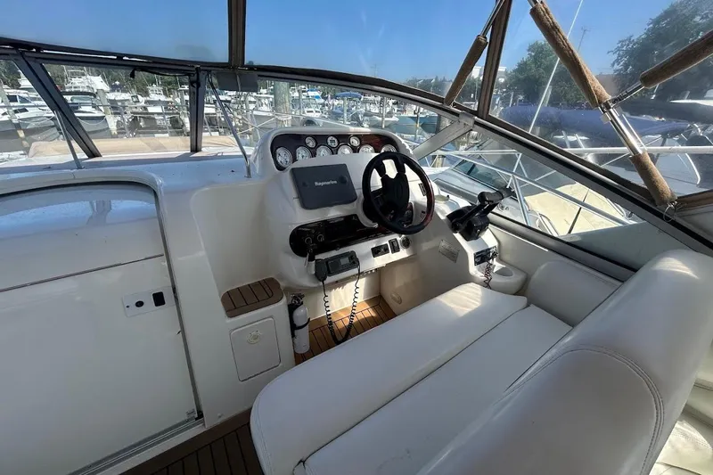 Slide: The Image of 2001 Larson Cabrio 330 boat cockpit with steering wheel and navigation equipment. - 6