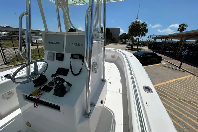 Slide: The Image of 2018 Contender 28 Tournament boat with Garmin navigation, parked near a black car. - 11