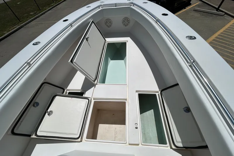 Slide: The Image of 2018 Contender 28 Tournament boat with open storage compartments on deck. - 14