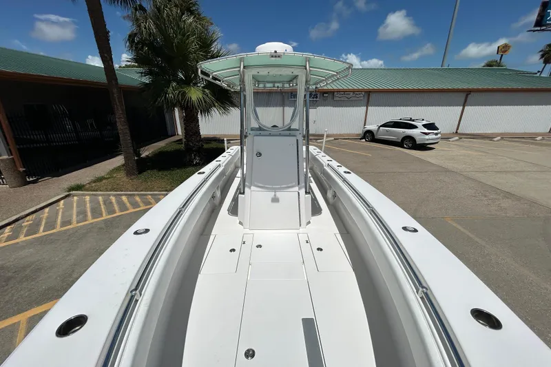 Slide: The Image of 2018 Contender 28 Tournament boat in parking lot, showcasing sleek design and spacious deck. - 16