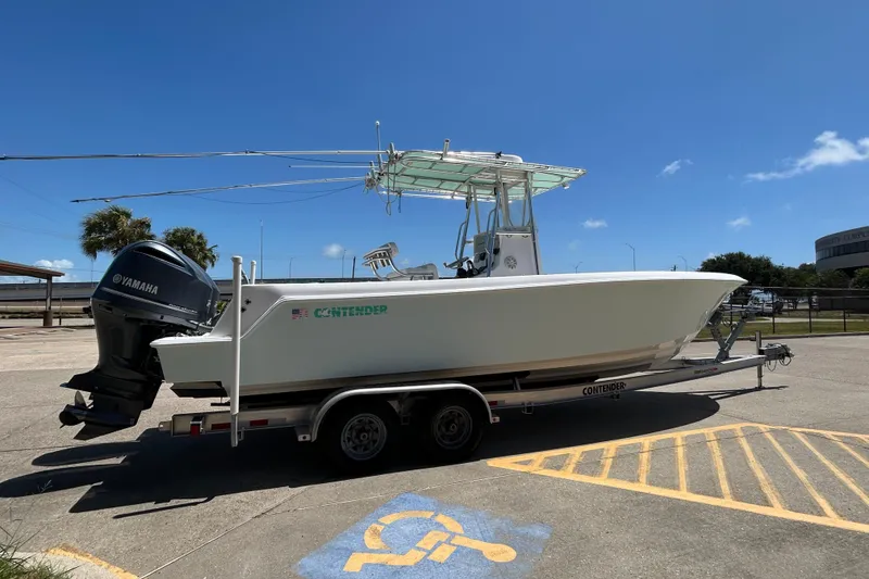 Slide: The Image of 2018 Contender 28 Tournament boat on trailer, parked in sunny lot. - 2
