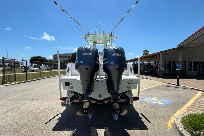 Slide: The Image of 2018 Contender 28 Tournament boat with dual Yamaha engines, parked in a lot. - 3