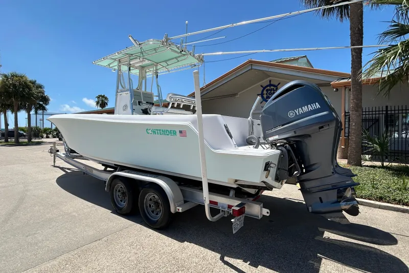 Slide: The Image of 2018 Contender 28 Tournament boat with Yamaha engine on trailer, parked outdoors. - 4