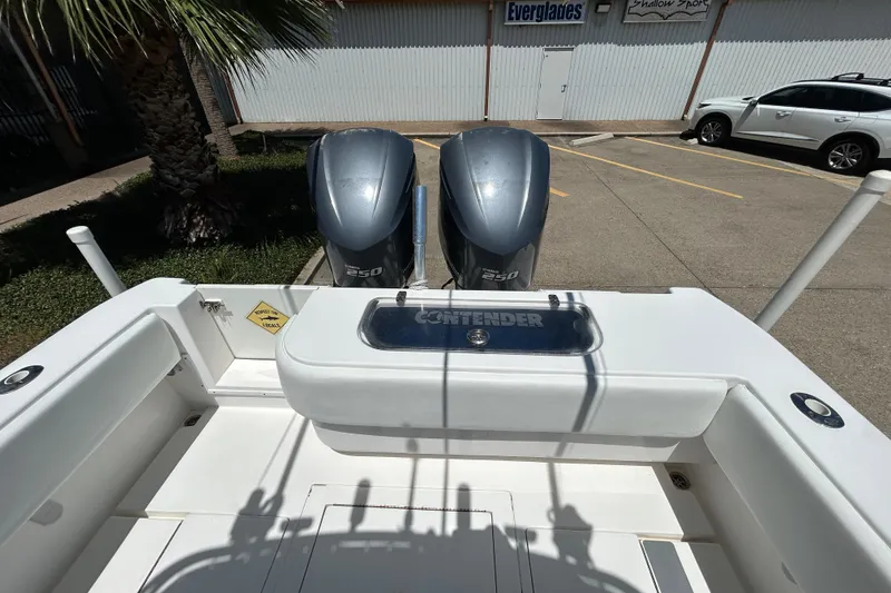 Slide: The Image of 2018 Contender 28 Tournament boat with dual 250 horsepower engines in a parking lot. - 7