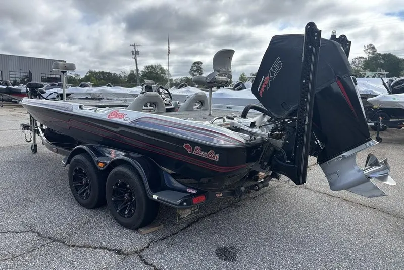 Slide: The Image of 2020 Bass Cat Cougar FTD boat with dual axle trailer, parked outdoors. - 19