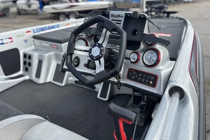 Slide: The Image of 2020 Bass Cat Cougar FTD boat dashboard with steering wheel and gauges. - 2
