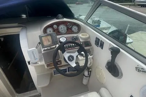 Slide: The Image of 2003 Rinker Fiesta Vee 270 boat cockpit with steering wheel and navigation instruments. - 4