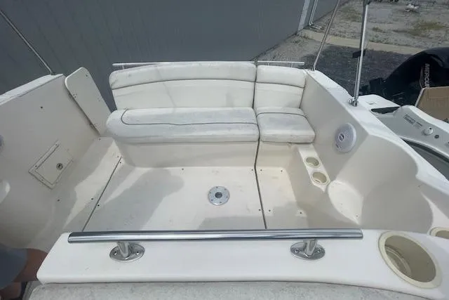 Slide: The Image of 2003 Rinker Fiesta Vee 270 boat interior with white seating and cup holders. - 7