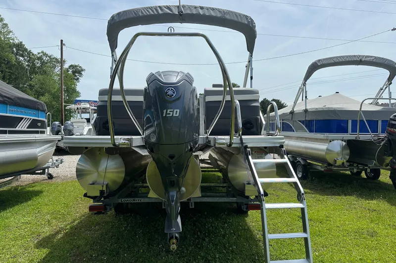 Slide: The Image of 2025 Bennington 22M pontoon boat with Yamaha 150 engine, displayed outdoors. - 4