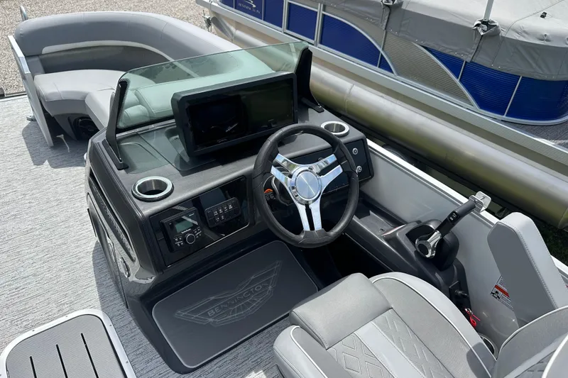 Slide: The Image of 2025 Bennington 22M boat interior with steering wheel and control panel. - 6