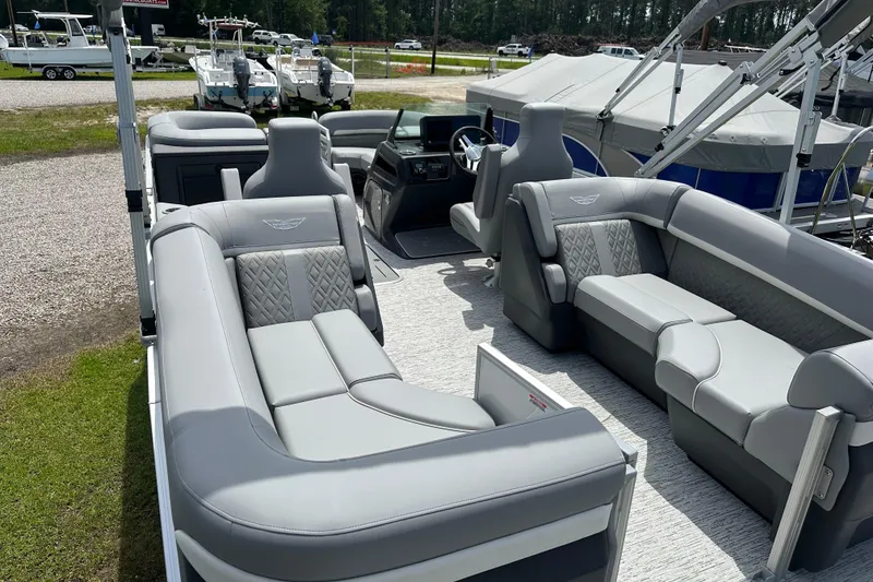 Slide: The Image of 2025 Bennington 22M pontoon boat interior with luxurious gray seating and modern design. - 7
