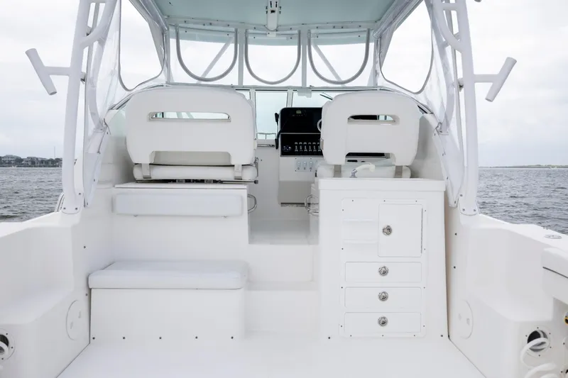Slide: The Image of 2017 Stamas 370 Aegean boat interior with helm seats and storage, on open water. - 17