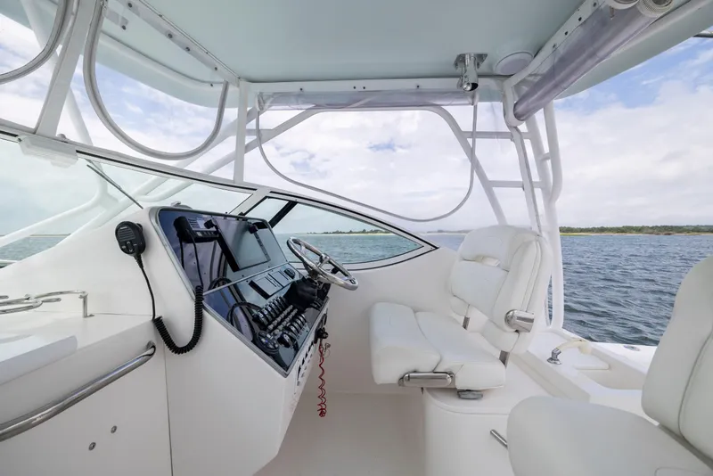 Slide: The Image of 2017 Stamas 370 Aegean boat interior with helm, steering wheel, and seating on open water. - 19