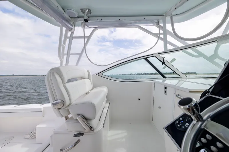 Slide: The Image of 2017 Stamas 370 Aegean boat interior with helm, white seating, and ocean view. - 23