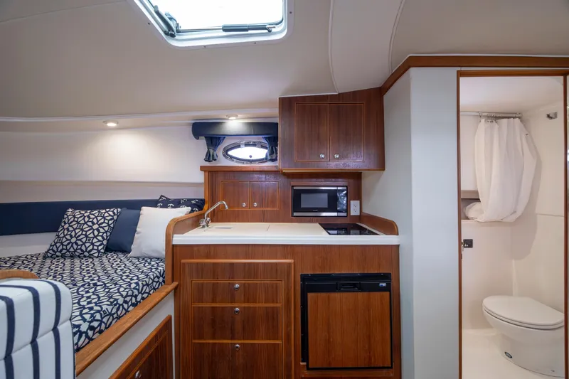 Slide: The Image of 2017 Stamas 370 Aegean interior with kitchenette, bed, and bathroom. Luxurious yacht cabin design. - 26